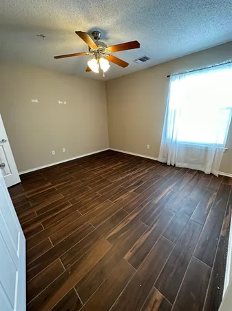 a view of an empty room with a kitchen