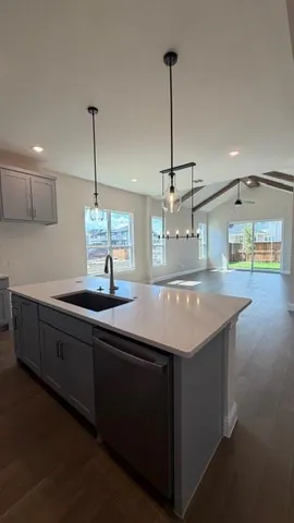 a view of a kitchen with a sink and chandelier