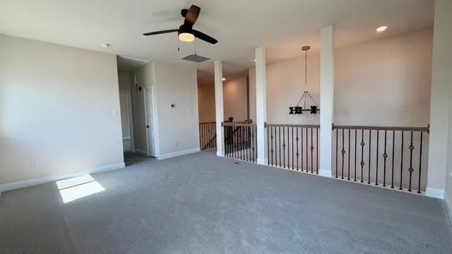 a view of a hallway with a ceiling fan