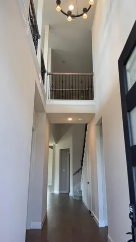 a view of staircase with white walls and a window