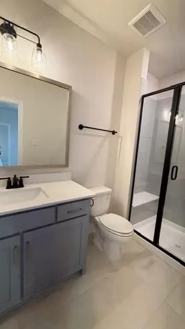 a bathroom with a sink a mirror and a toilet