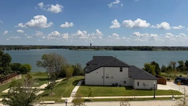 a view of a houses with outside space and a lake view