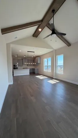 a view of a livingroom with hardwood floor and a ceiling fan