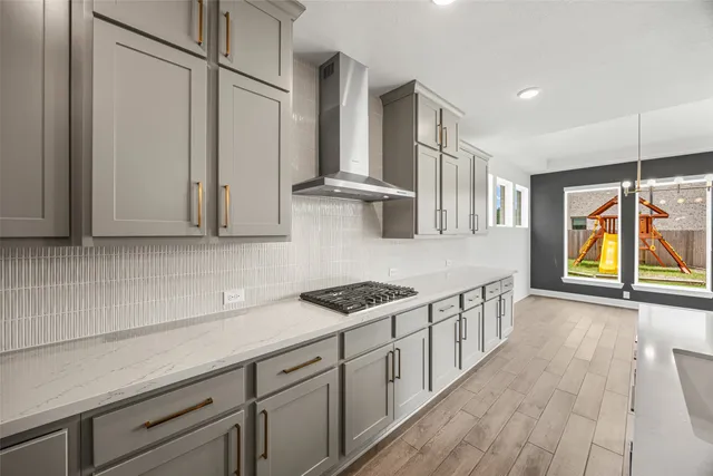 a kitchen with stainless steel appliances granite countertop a sink and wooden cabinets