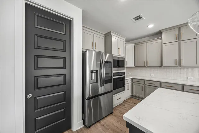a kitchen with a refrigerator and a sink