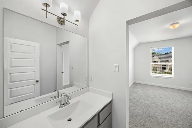 a bathroom with a sink a vanity and a mirror