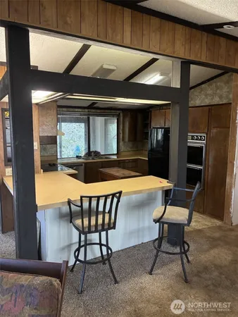 a kitchen with stainless steel appliances granite countertop a refrigerator and a stove