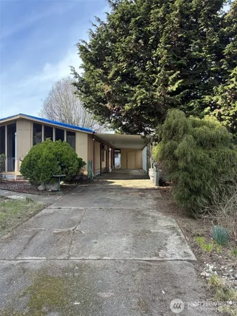 a front view of a house with a yard and a garage