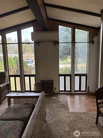 a view of a livingroom with furniture and a flat screen tv