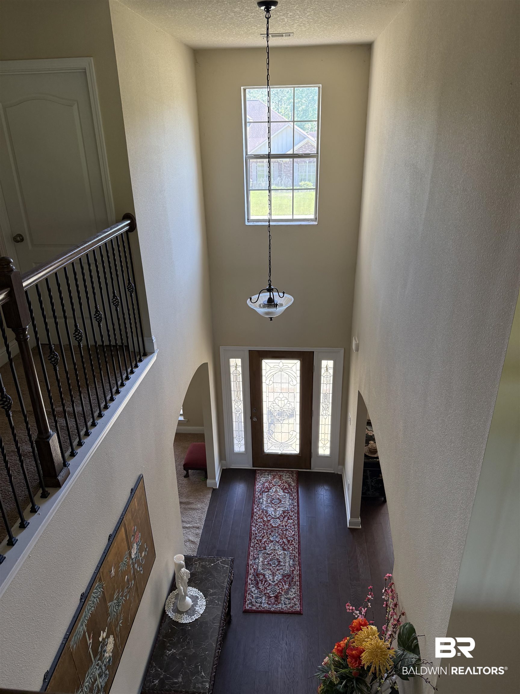 9023 Krystal Ridge Court Daphne, AL 36526 - Photo 26 of 41 Foyer with arched walkways, wood-type flooring, a high ceiling, a textured ceiling, and a textured wall