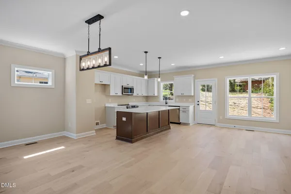 a living room with furniture kitchen and a kitchen view