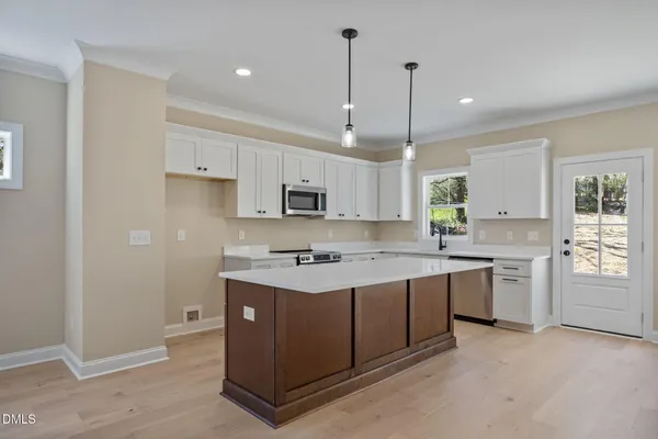 a large white kitchen with a large window