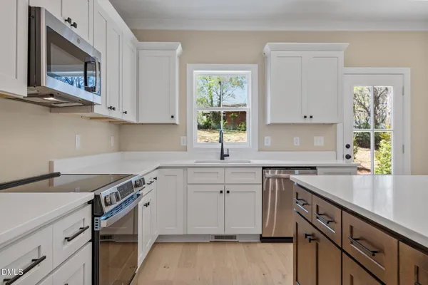a kitchen with a sink stove and cabinets