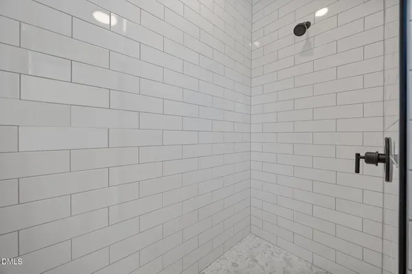a bathroom with a double vanity sink mirror and shower