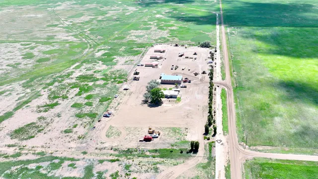 a view of a terrace with lawn chairs