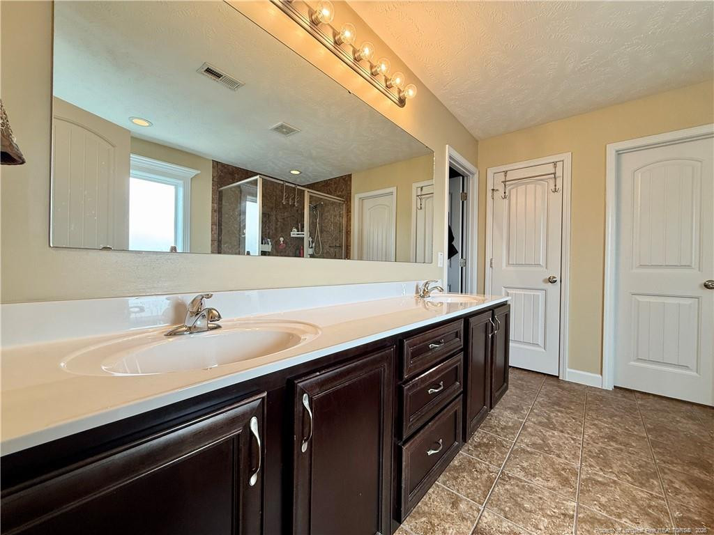 35 Ambrose Point Cameron, NC 28326 - Photo 20 of 31 a bathroom with a sink and a mirror