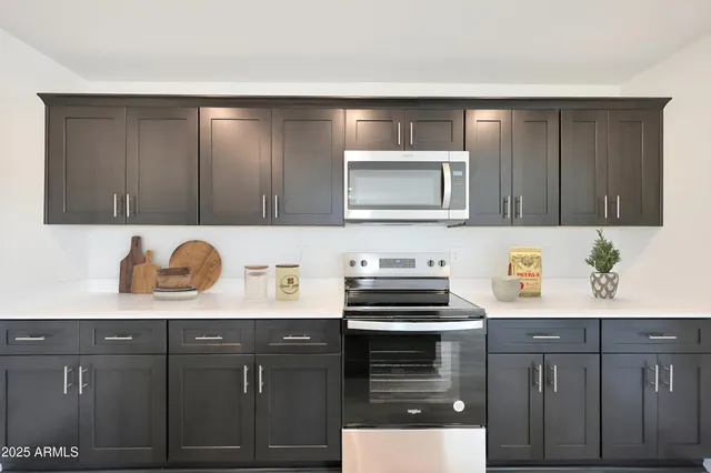 a kitchen with stainless steel appliances wooden cabinets and a stove top oven
