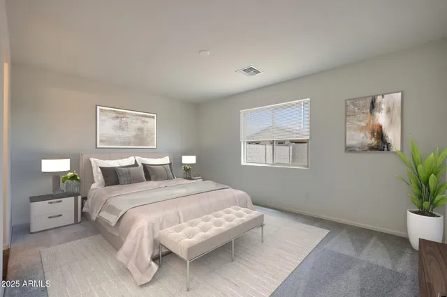 a bedroom with a large bed and a potted plant