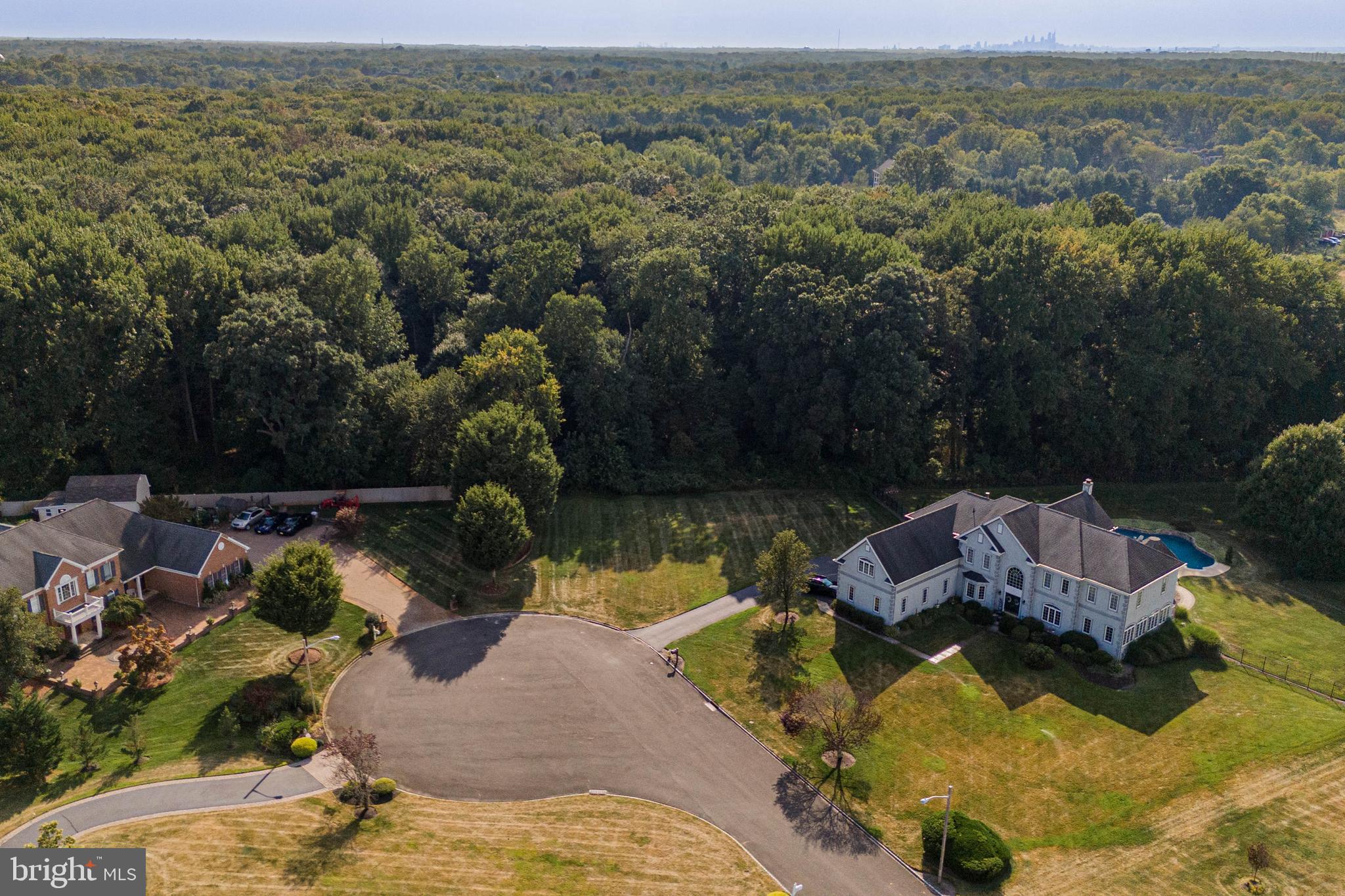 700 Bentley Court Moorestown, NJ 08057 - Photo 3 of 4 an aerial view of a house with a garden and lake view