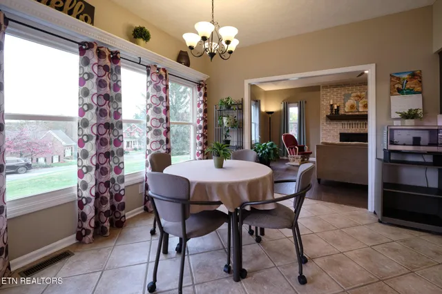 a view of a dining room with furniture and chandelier