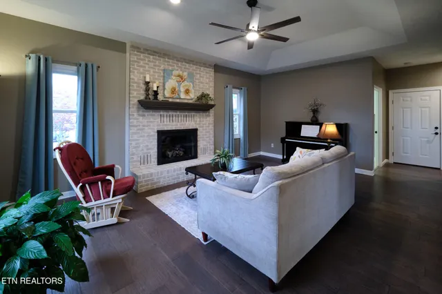 a living room with furniture and a fireplace