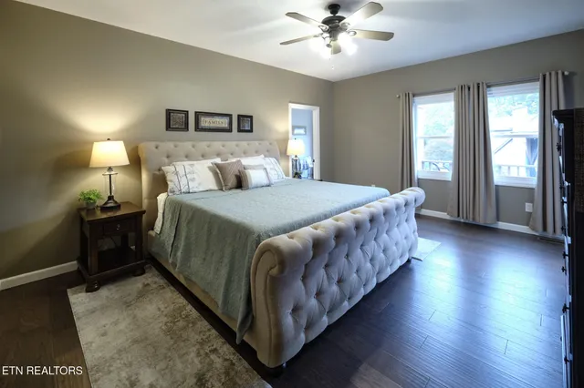 a bedroom with a large bed and a chandelier