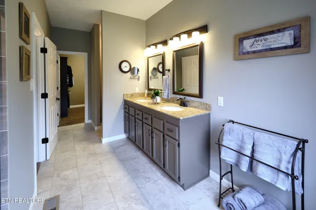 a bathroom with a sink a mirror and a shower