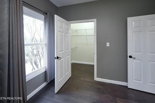 a bedroom with a bed and a potted plant