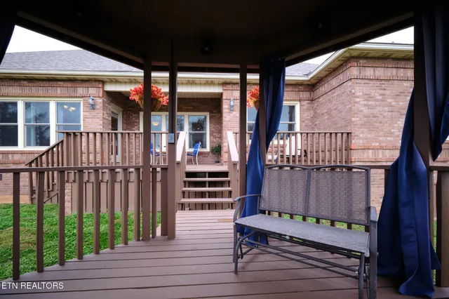 a view of a chair and table in the garden