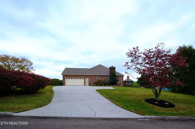 an aerial view of a house with pool lake view and mountain view