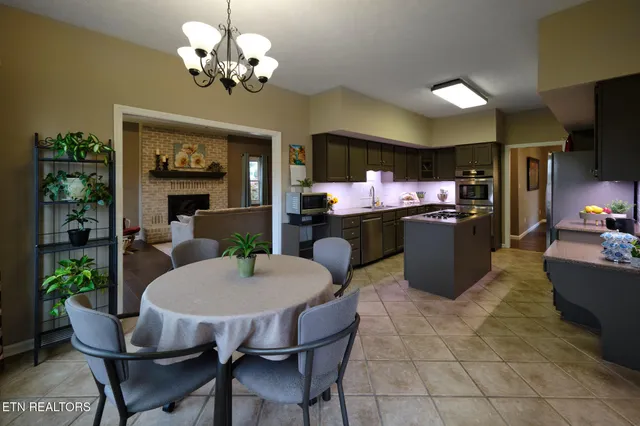 a view of a dining room with furniture and a chandelier