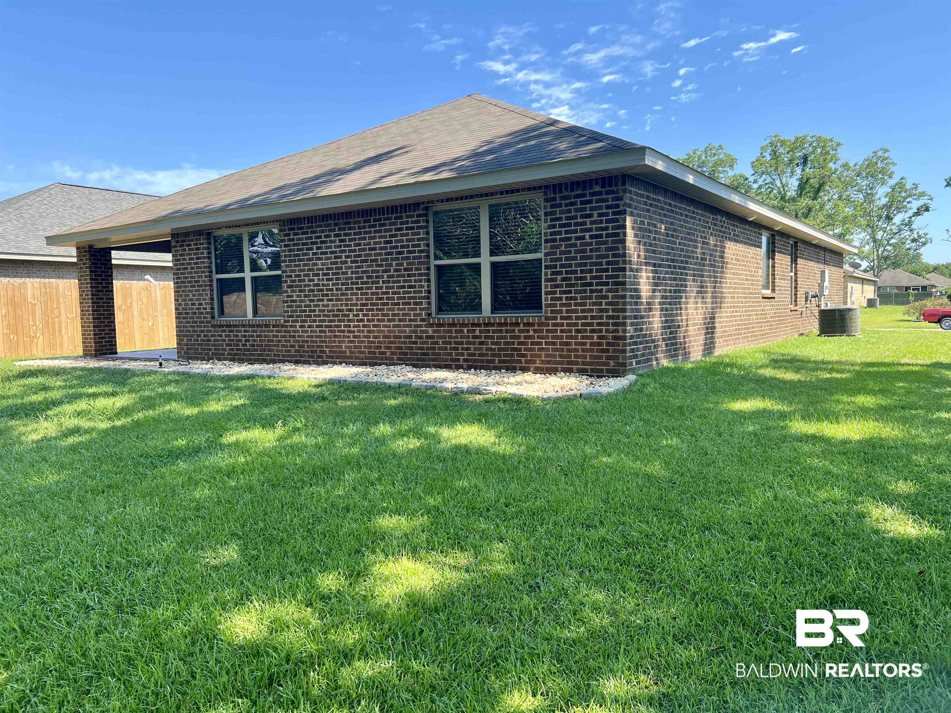 1612 Abbey Loop Foley, AL 36535 - Photo 2 of 30 Back of property with central air condition unit and a lawn