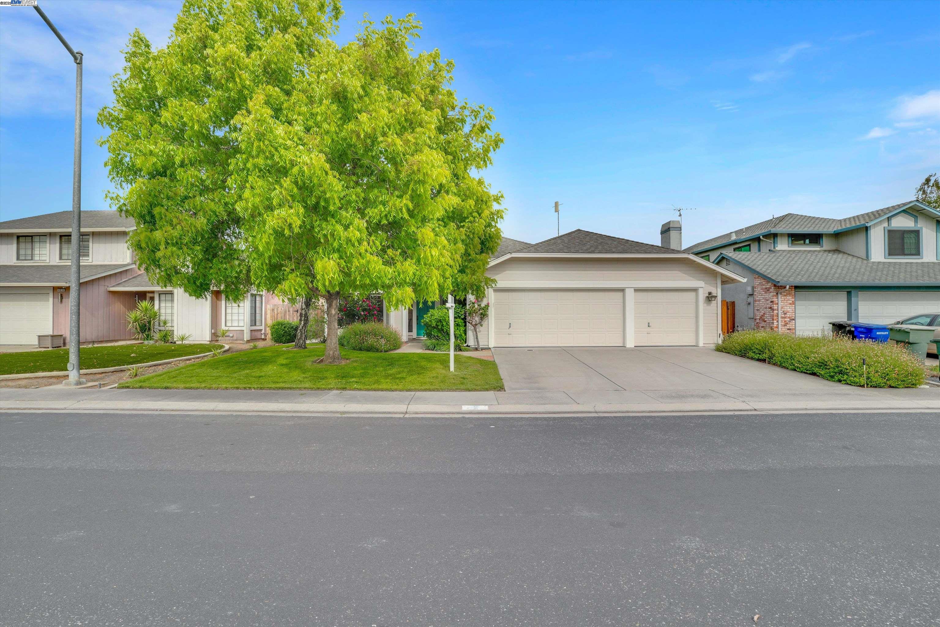 a front view of a house with a garden and garage