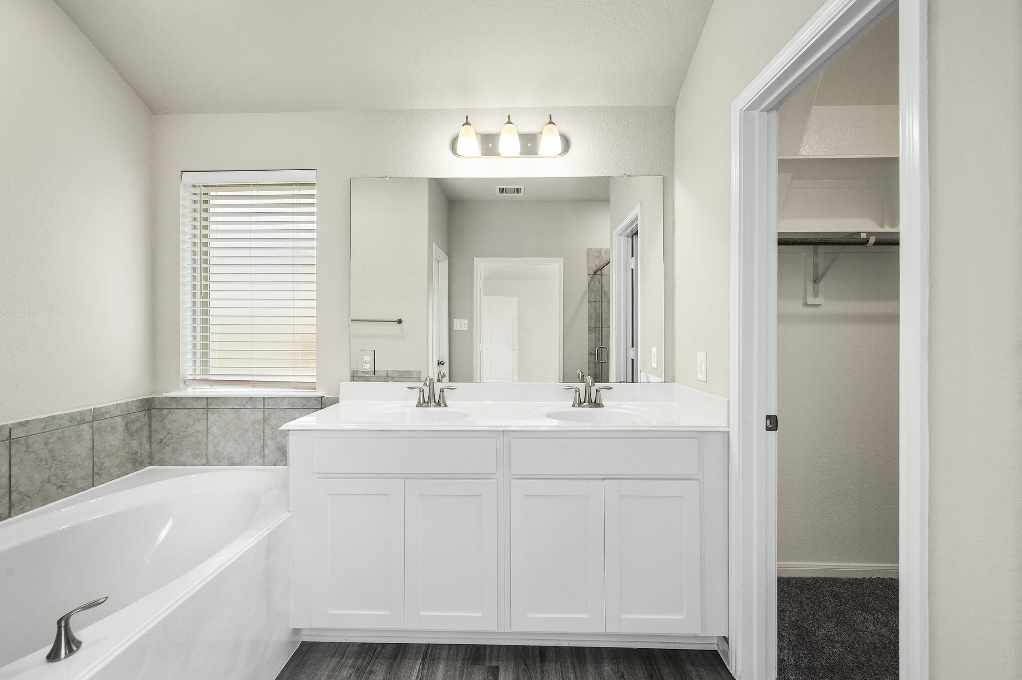 4507 Frontier Trail Baytown, TX 77521 - Photo 13 of 24 a bathroom with a sink tub double vanity and mirror