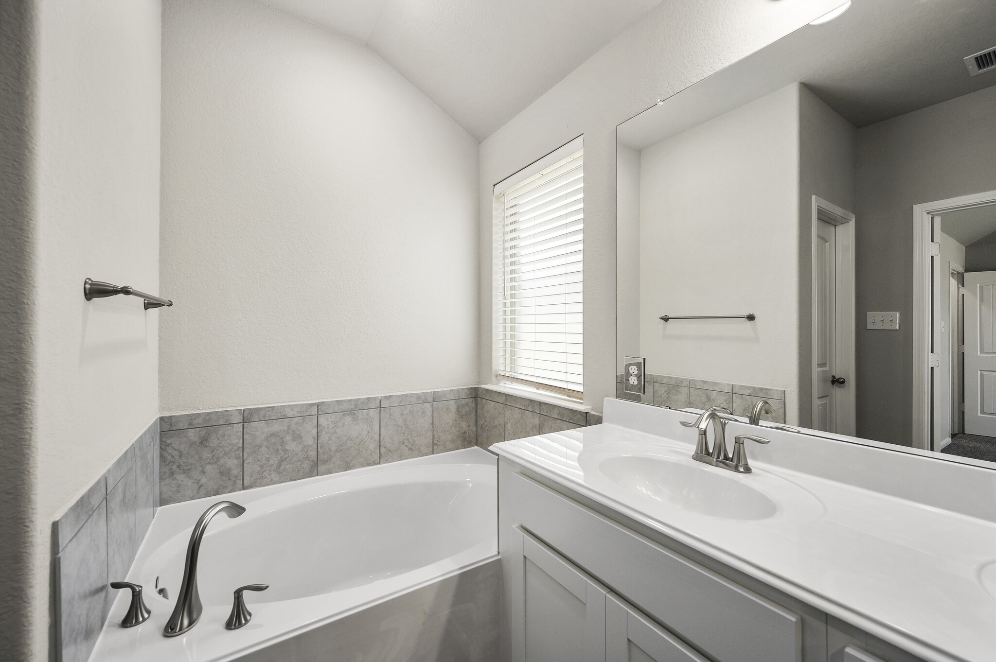 4507 Frontier Trail Baytown, TX 77521 - Photo 15 of 24 a bathroom with a tub sink and mirror