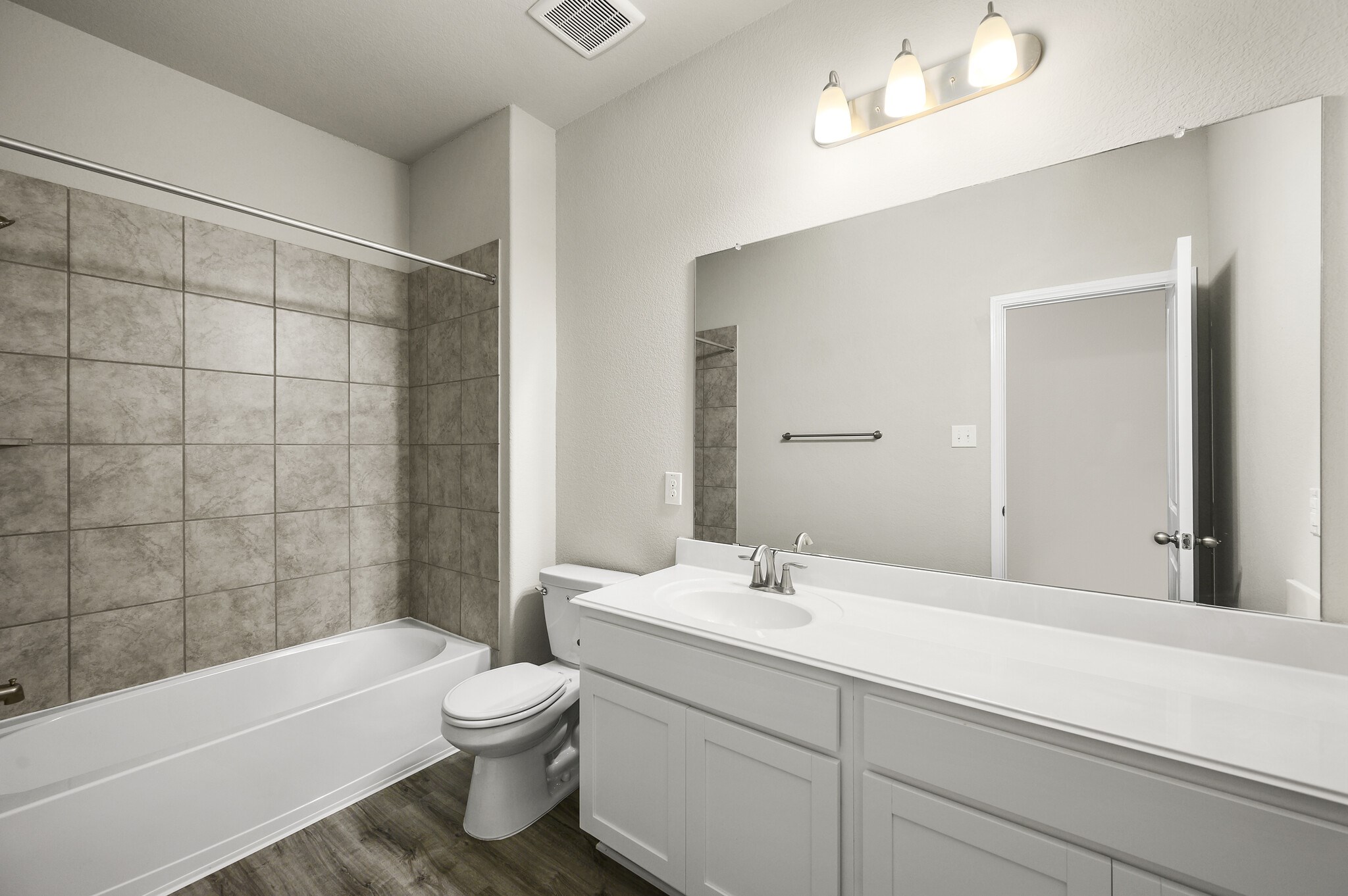 4507 Frontier Trail Baytown, TX 77521 - Photo 19 of 24 a bathroom with a bathtub shower sink vanity and toilet