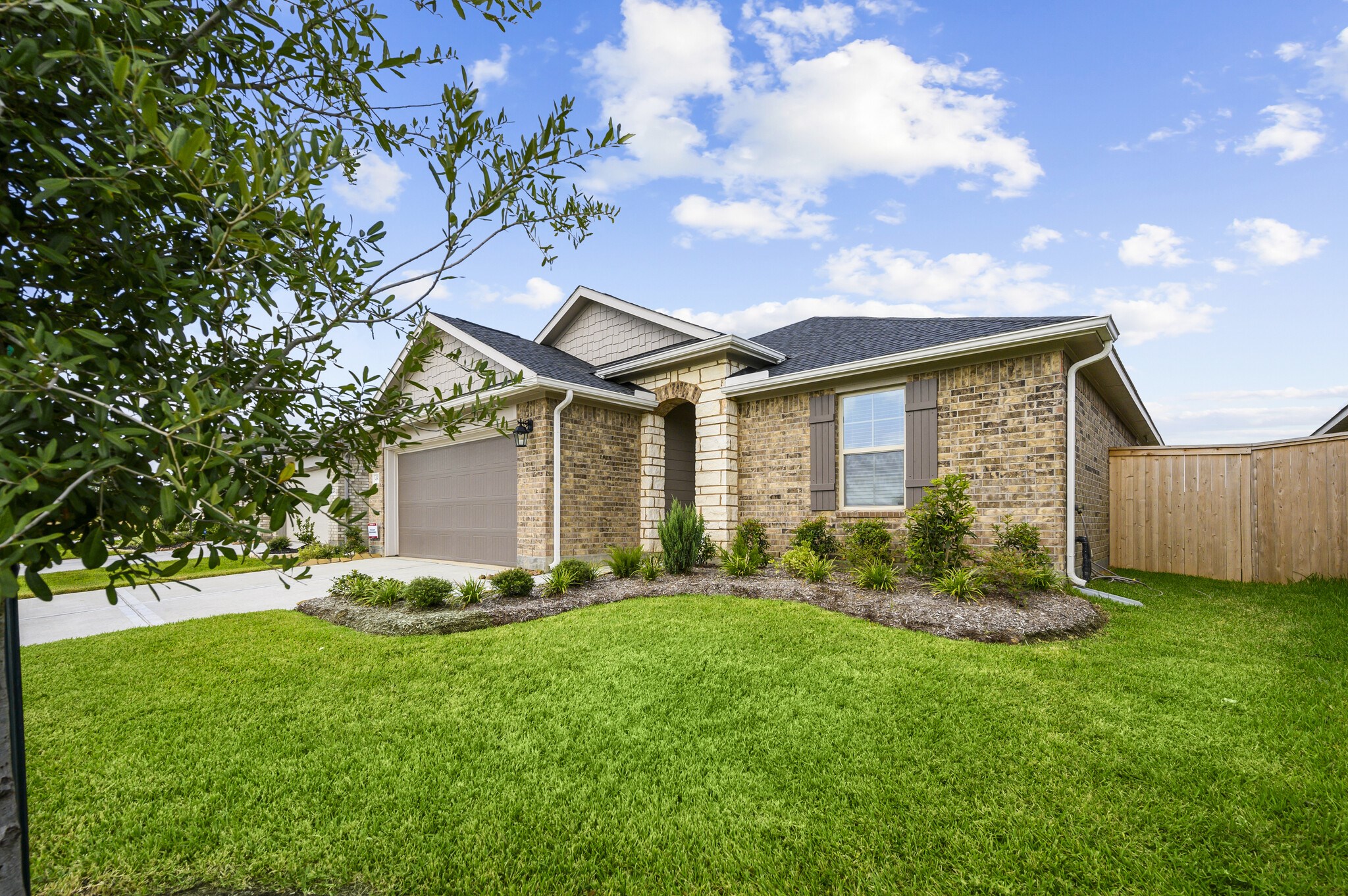 4507 Frontier Trail Baytown, TX 77521 - Photo 3 of 24 a front view of a house with a garden and yard