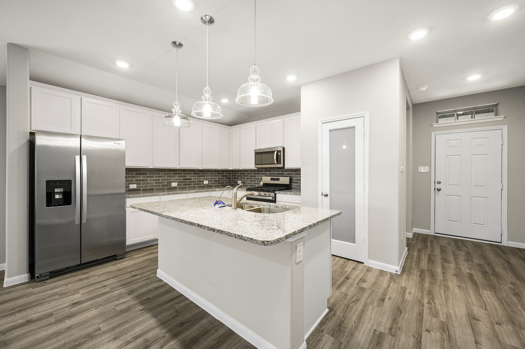 4507 Frontier Trail Baytown, TX 77521 - Photo 6 of 24 a kitchen with a refrigerator a sink and cabinets