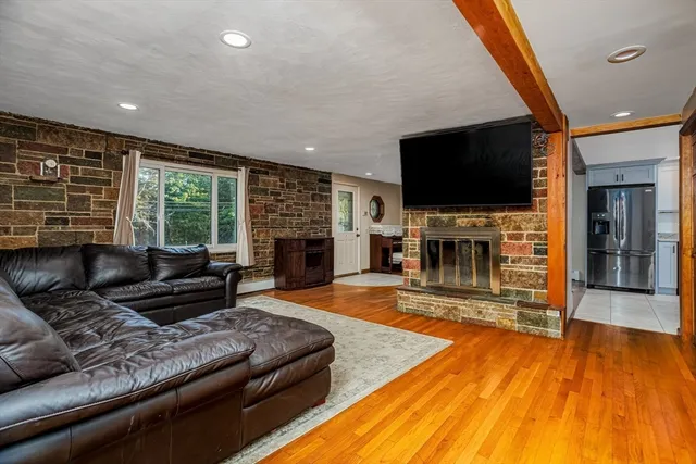 a living room with fireplace furniture and a flat screen tv