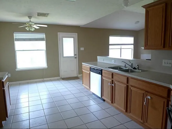 a kitchen with stainless steel appliances a sink stove and cabinets