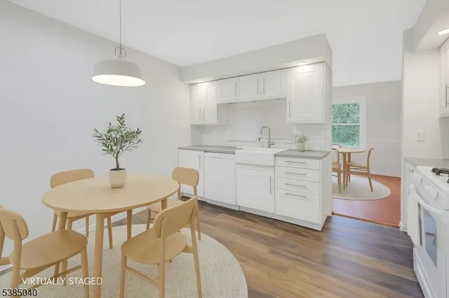 a kitchen with a table chairs sink and cabinets