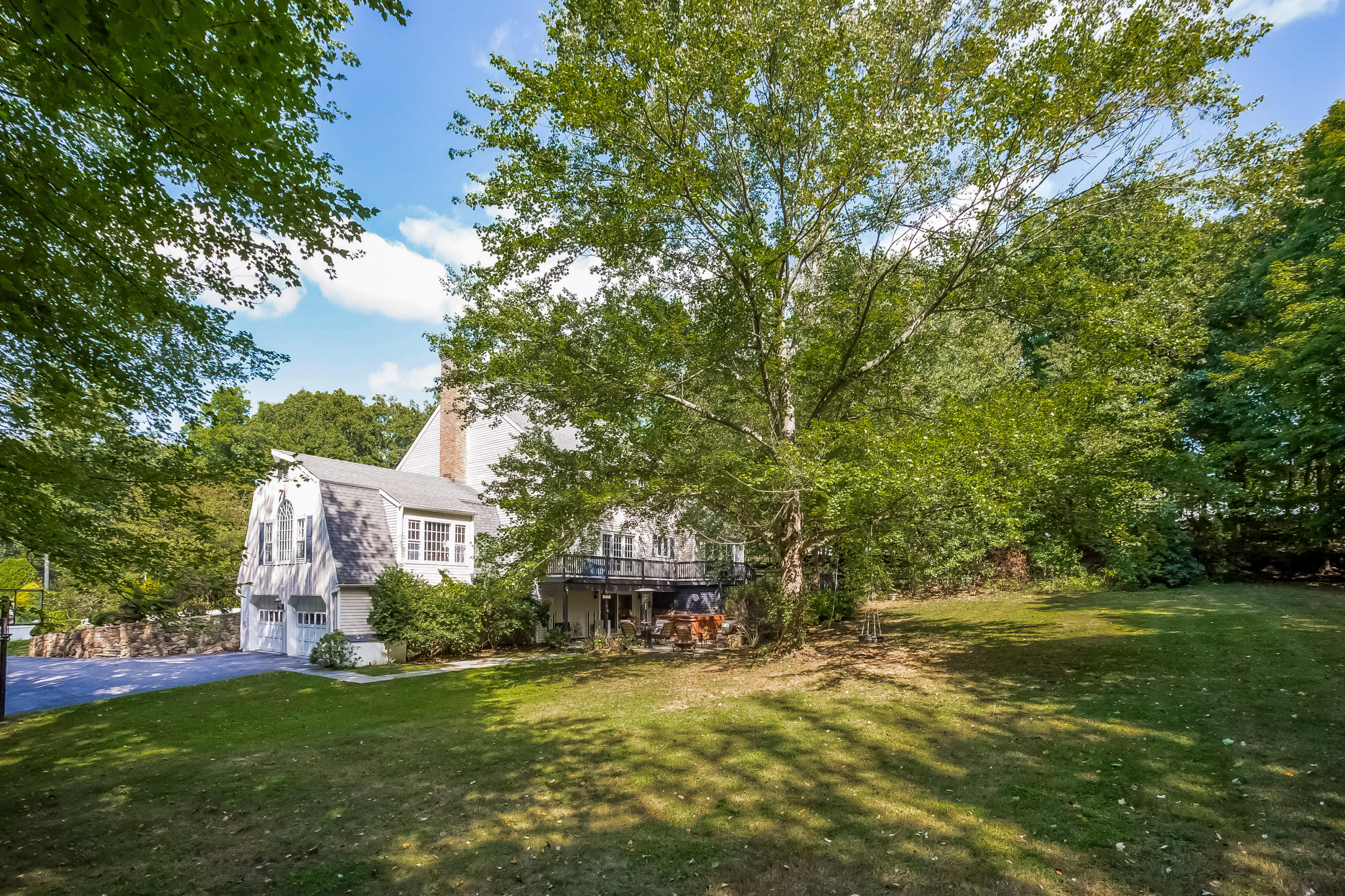 259 Marvin Ridge Road New Canaan, CT 06840 - Photo 31 of 38 a front view of a house with a garden and tree