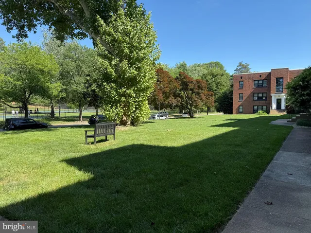 a view of a park with a house in the background