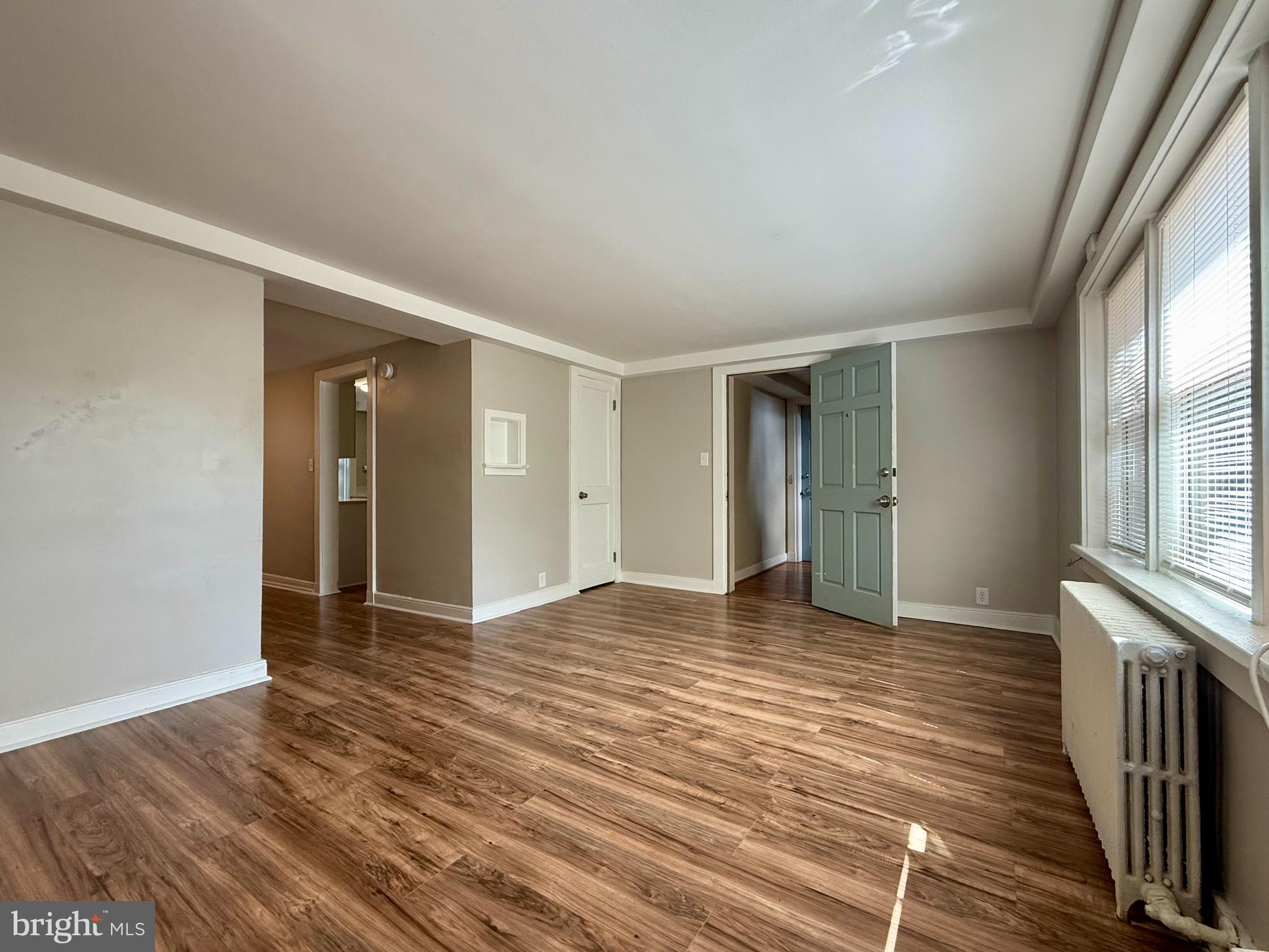 1400 Kenmore Avenue, Unit E1 Fredericksburg, VA 22401 - Photo 3 of 11 a view of an empty room with wooden floor and a window