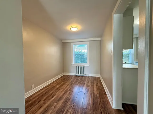 a view of room with window and wooden floor