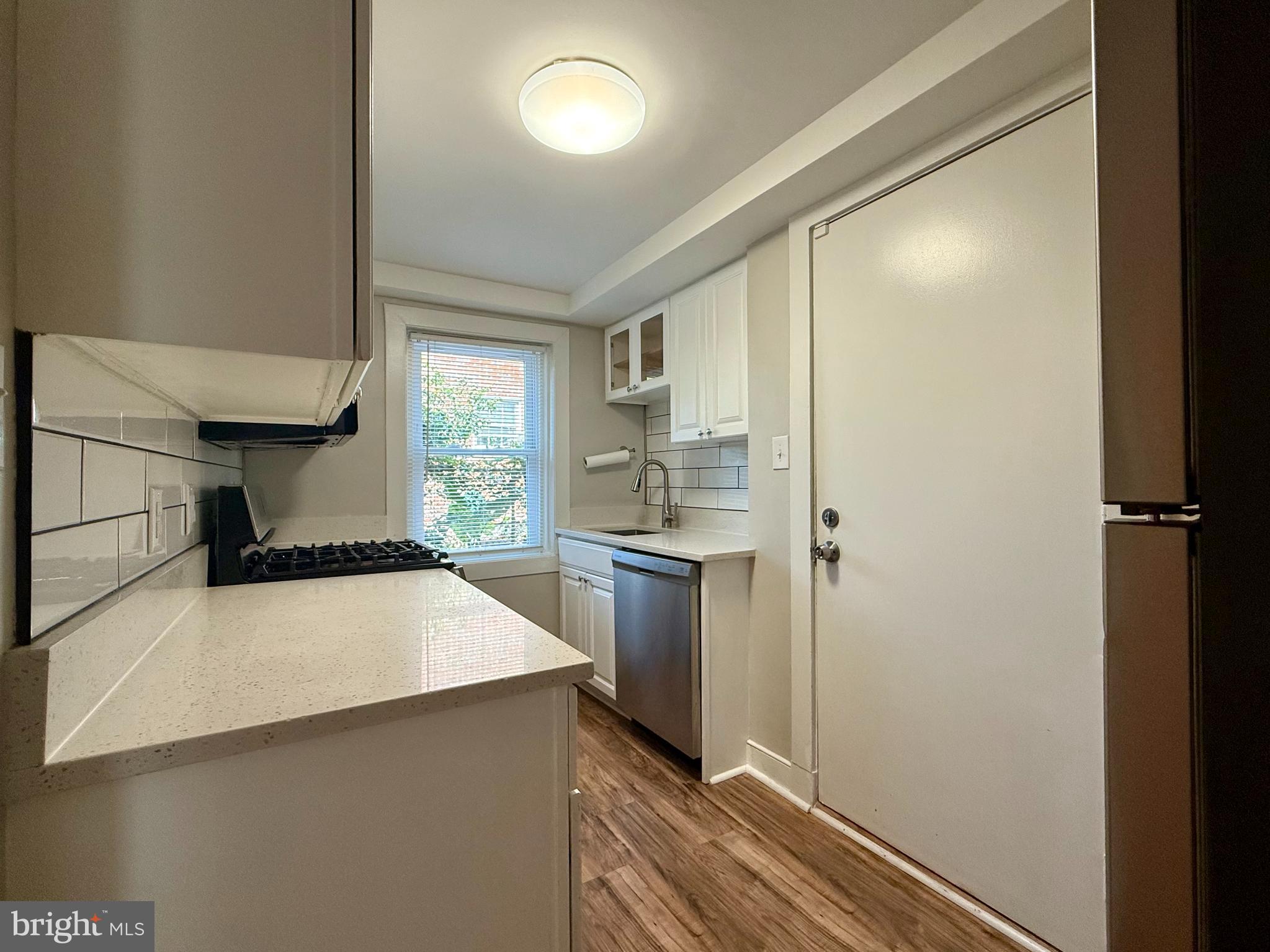 1400 Kenmore Avenue, Unit E1 Fredericksburg, VA 22401 - Photo 5 of 11 a kitchen with a refrigerator and a sink