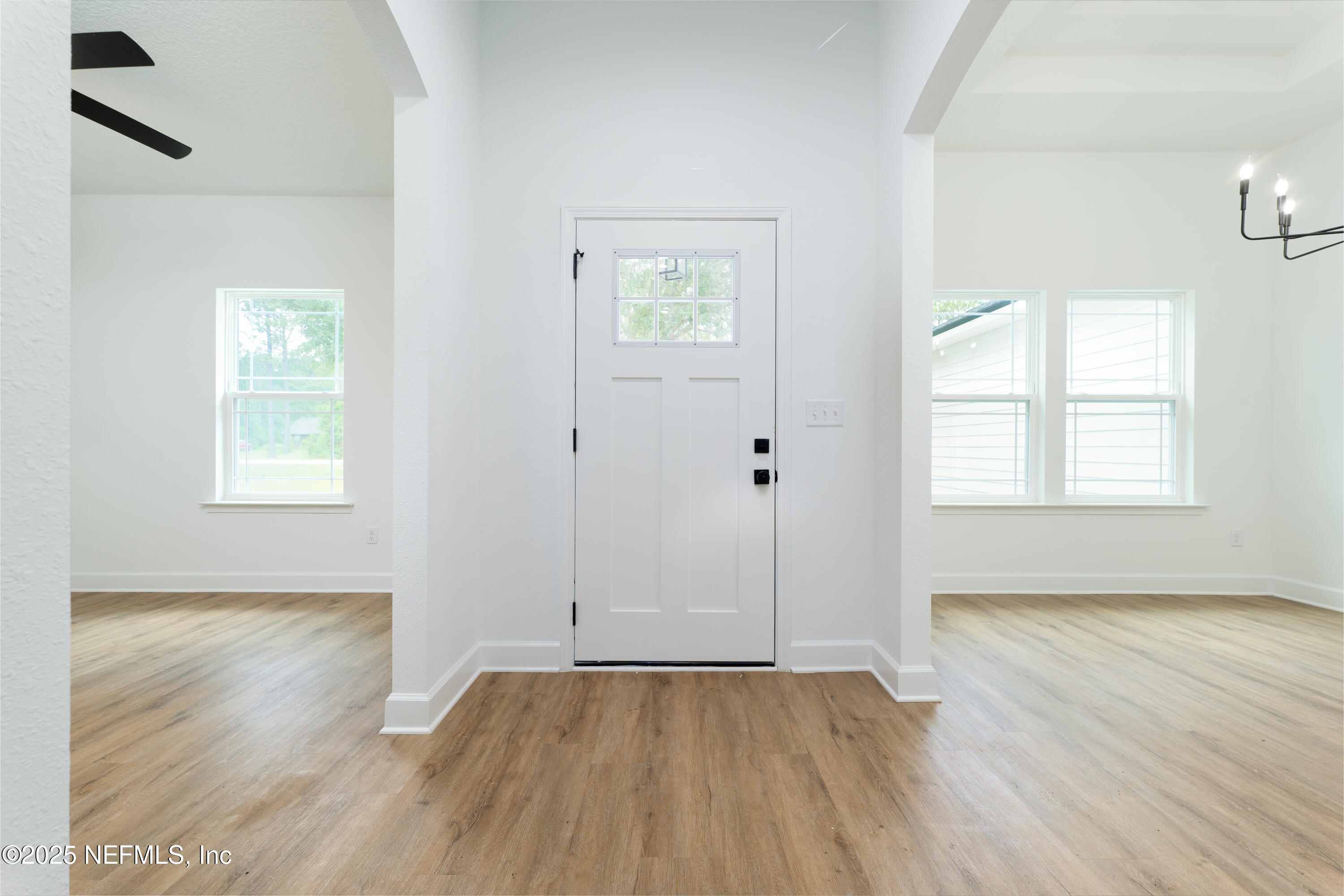 2482 Oleander Avenue Middleburg, FL 32068 - Photo 11 of 34 an empty room with wooden floor and windows