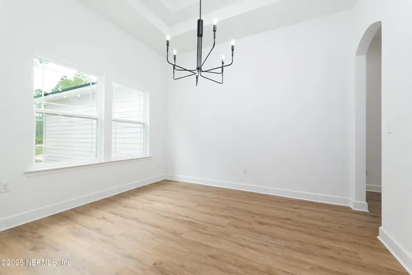 a view of a room with wooden floor and windows