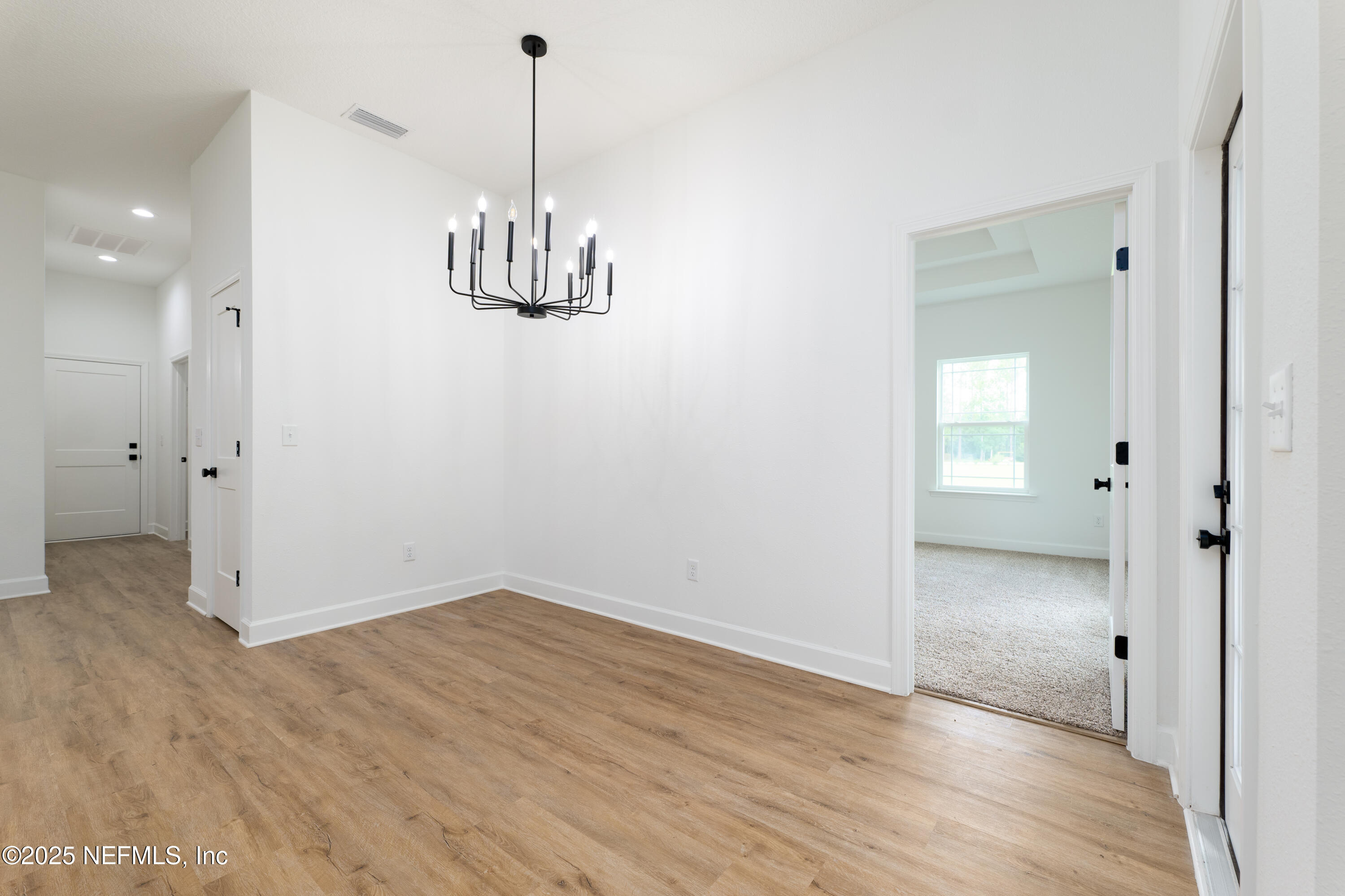 2482 Oleander Avenue Middleburg, FL 32068 - Photo 13 of 34 wooden floor in an empty room with a window
