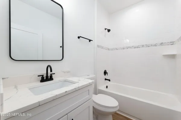 a bathroom with a sink a toilet and a bathtub